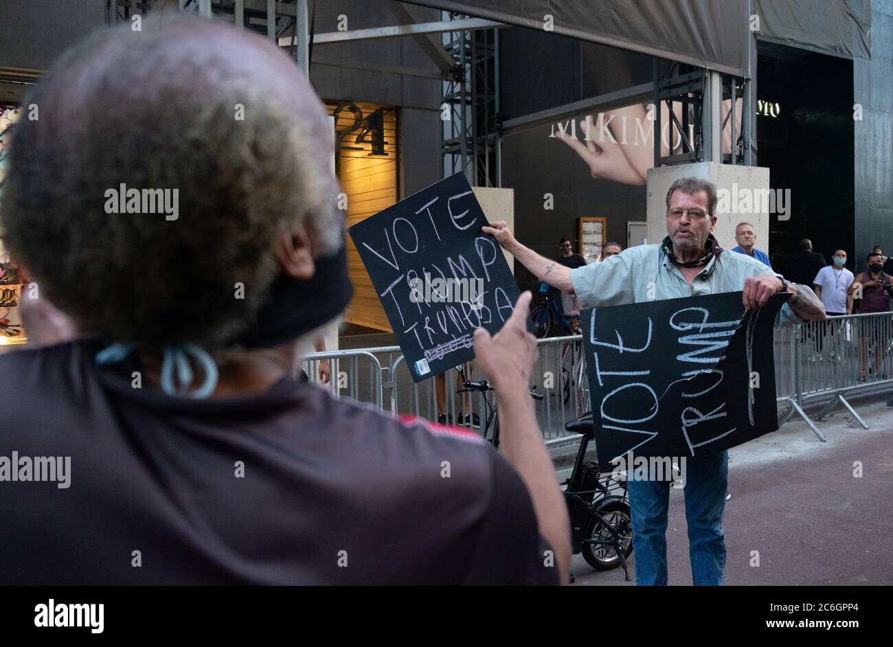 New York, United States. 08th July, 2020. A BLM protester argues with a Trump Supporter in front of Trump Tower where a large Black Lives Matter mural was paintedAs New York City enters phase 3 of reopening retail stores for indoor shopping, restaurants have been postponed for indoor dinning. Meanwhile Black Lives Matter protests continue in the city as the Mayor along with a group of people painted a large Black Lives Matter mural in front of Trump Tower on 5th Ave. Credit: SOPA Images Limited/Alamy Live News Stock Photo