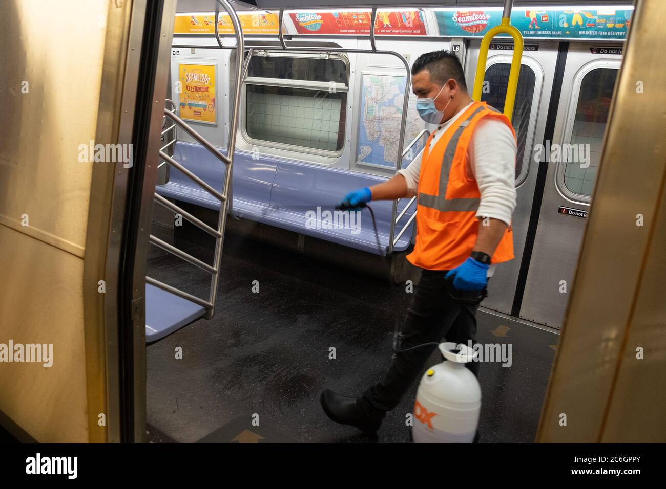 New York, United States. 08th July, 2020. A worker sprays a cleaning solution inside a subway car in Manhattan as the city enters phase 3 of reopening amid the coronavirus pandemic.As New York City enters phase 3 of reopening retail stores for indoor shopping, restaurants have been postponed for indoor dinning. Meanwhile Black Lives Matter protests continue in the city as the Mayor along with a group of people painted a large Black Lives Matter mural in front of Trump Tower on 5th Ave. Credit: SOPA Images Limited/Alamy Live News Stock Photo