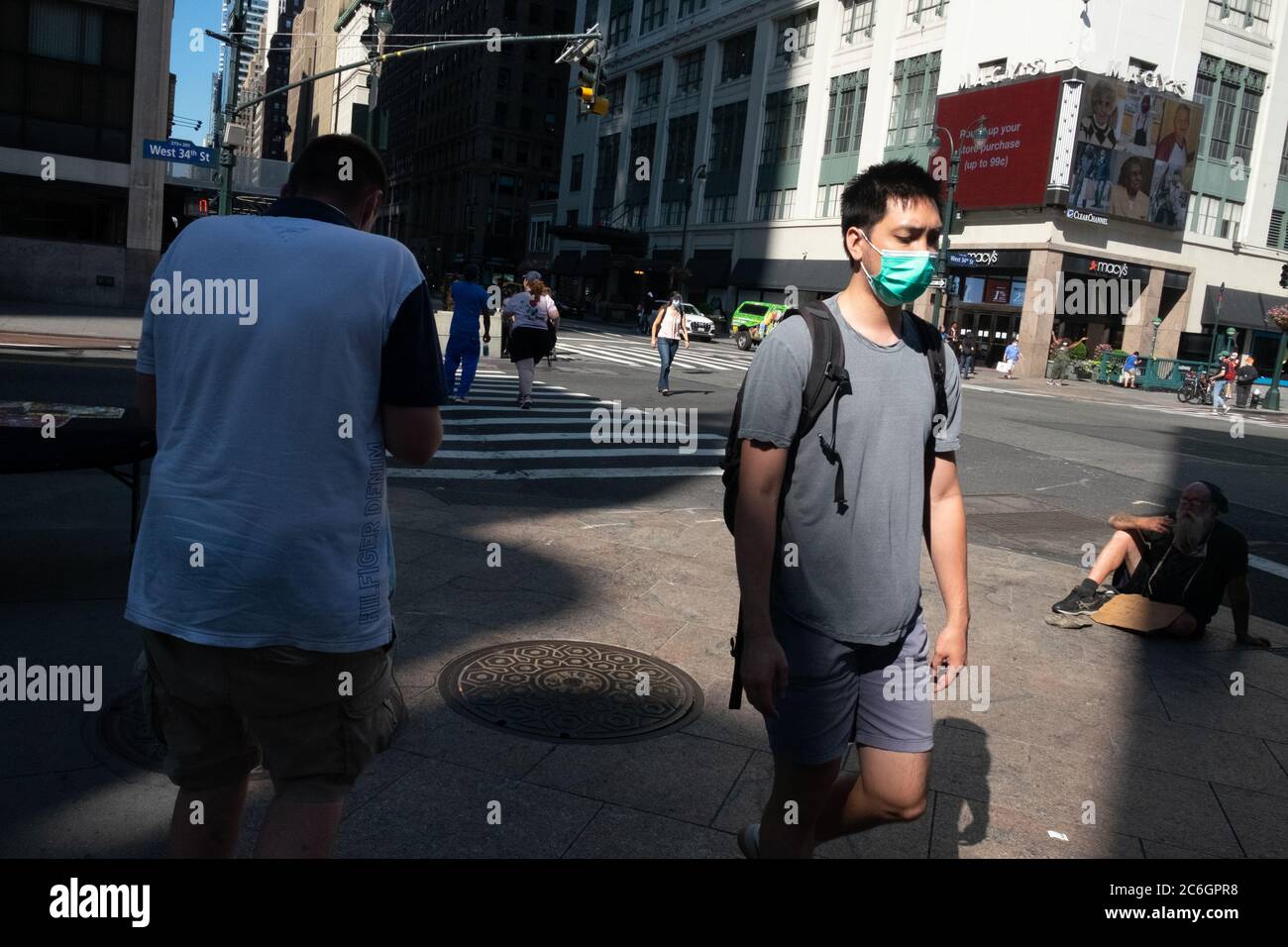 New York, United States. 08th July, 2020. A man wearing a face mask walking through midtown in Manhattan as the city enters phase 3 of reopening amid the coronavirus pandemic.As New York City enters phase 3 of reopening retail stores for indoor shopping, restaurants have been postponed for indoor dinning. Meanwhile Black Lives Matter protests continue in the city as the Mayor along with a group of people painted a large Black Lives Matter mural in front of Trump Tower on 5th Ave. Credit: SOPA Images Limited/Alamy Live News Stock Photo