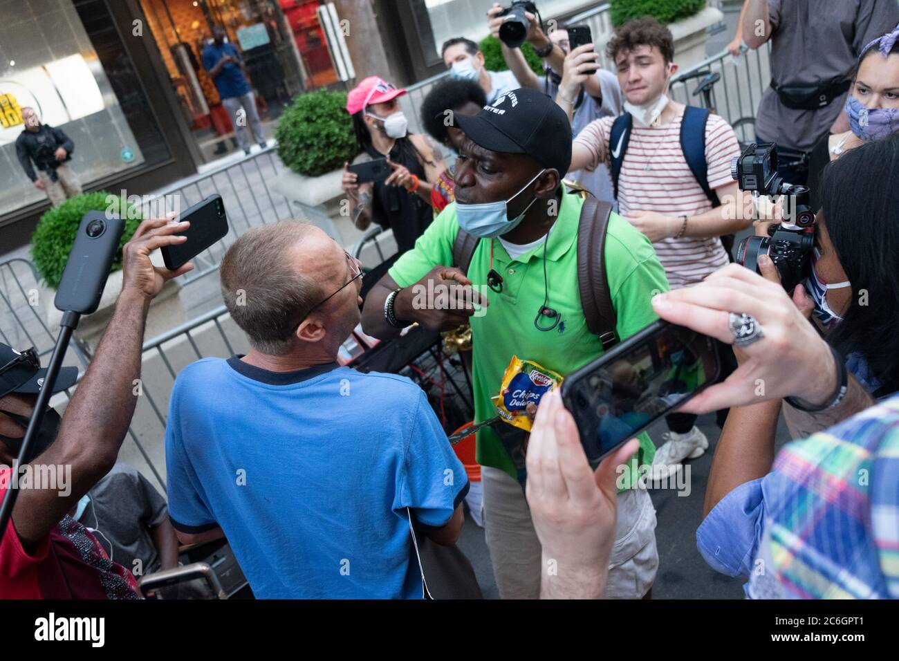 New York, United States. 08th July, 2020. An altercation between a Trump supporter and a BLM protester in front of Trump Tower in Manhattan where a large Black Lives Matter mural was painted.As New York City enters phase 3 of reopening retail stores for indoor shopping, restaurants have been postponed for indoor dinning. Meanwhile Black Lives Matter protests continue in the city as the Mayor along with a group of people painted a large Black Lives Matter mural in front of Trump Tower on 5th Ave. Credit: SOPA Images Limited/Alamy Live News Stock Photo