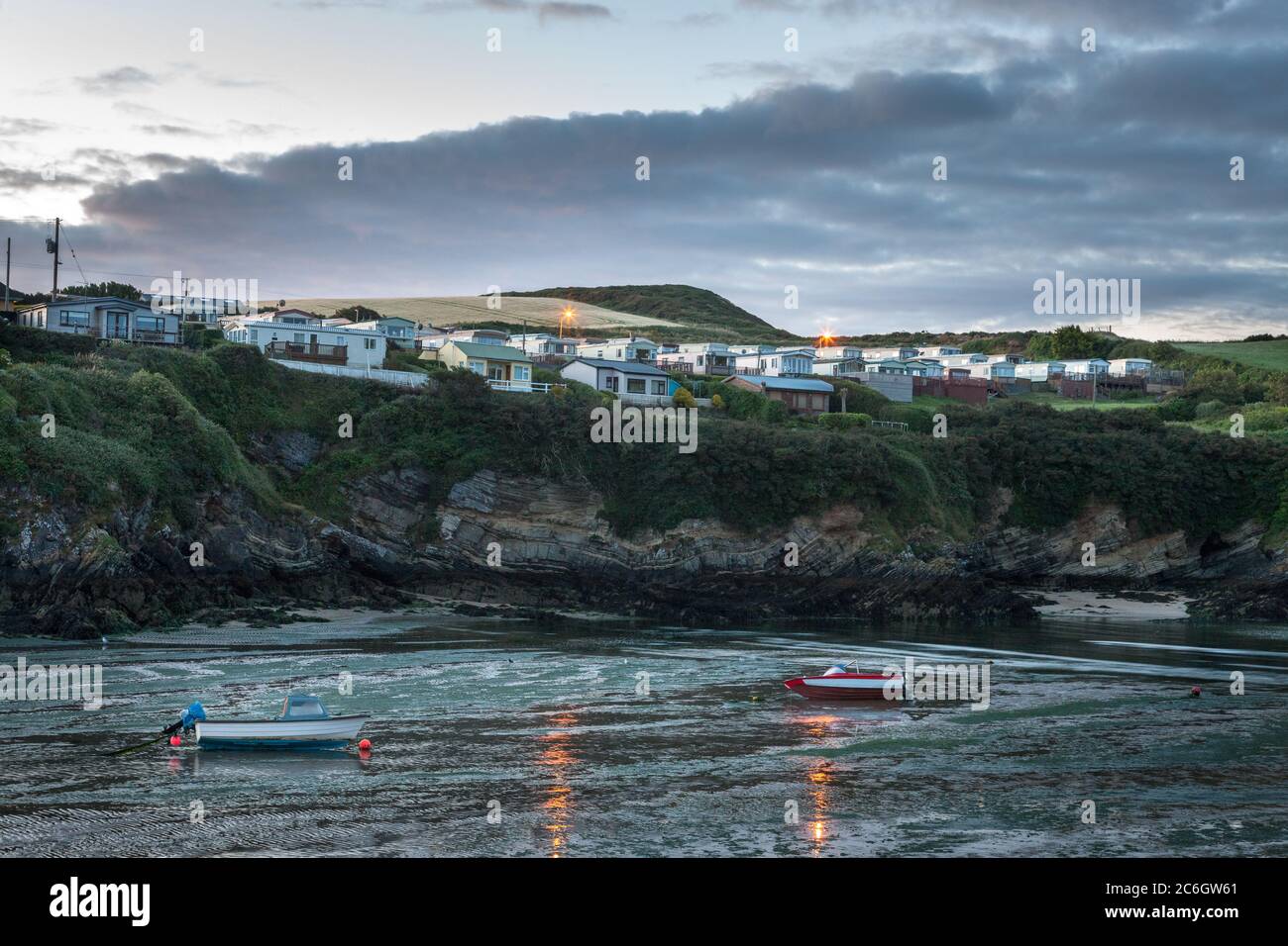 Roberts Cove, Cork, Ireland. 10th July, 2020. Holiday homes and caravans as early morning light illuminates the picturesque seaside village of Roberts Cove, Co. Cork, Ireland. The weather for the day is dry with sunny spells and a just a few scattered showers with highs of 15 to 17 degrees. Credit; David Creedon / Alamy Live News Stock Photo
