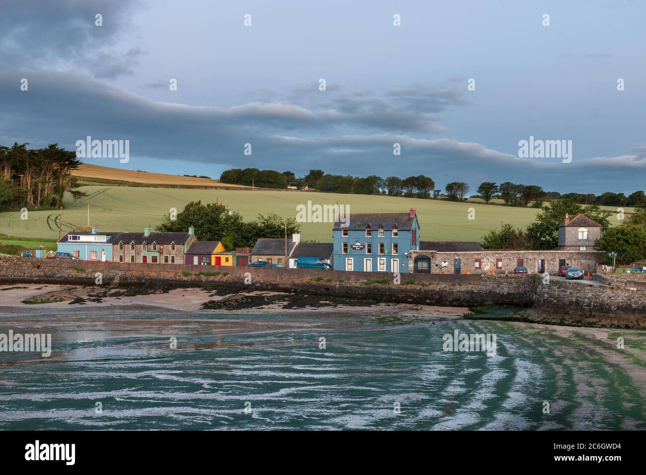 Roberts Cove, Cork, Ireland. 10th July, 2020.Early morning light illuminates the picturesque seaside village of Roberts Cove, Co. Cork, Ireland. The weather for the day is dry with sunny spells and a just a few scattered showers with highs of 15 to 17 degrees. Credit; David Creedon / Alamy Live News Stock Photo