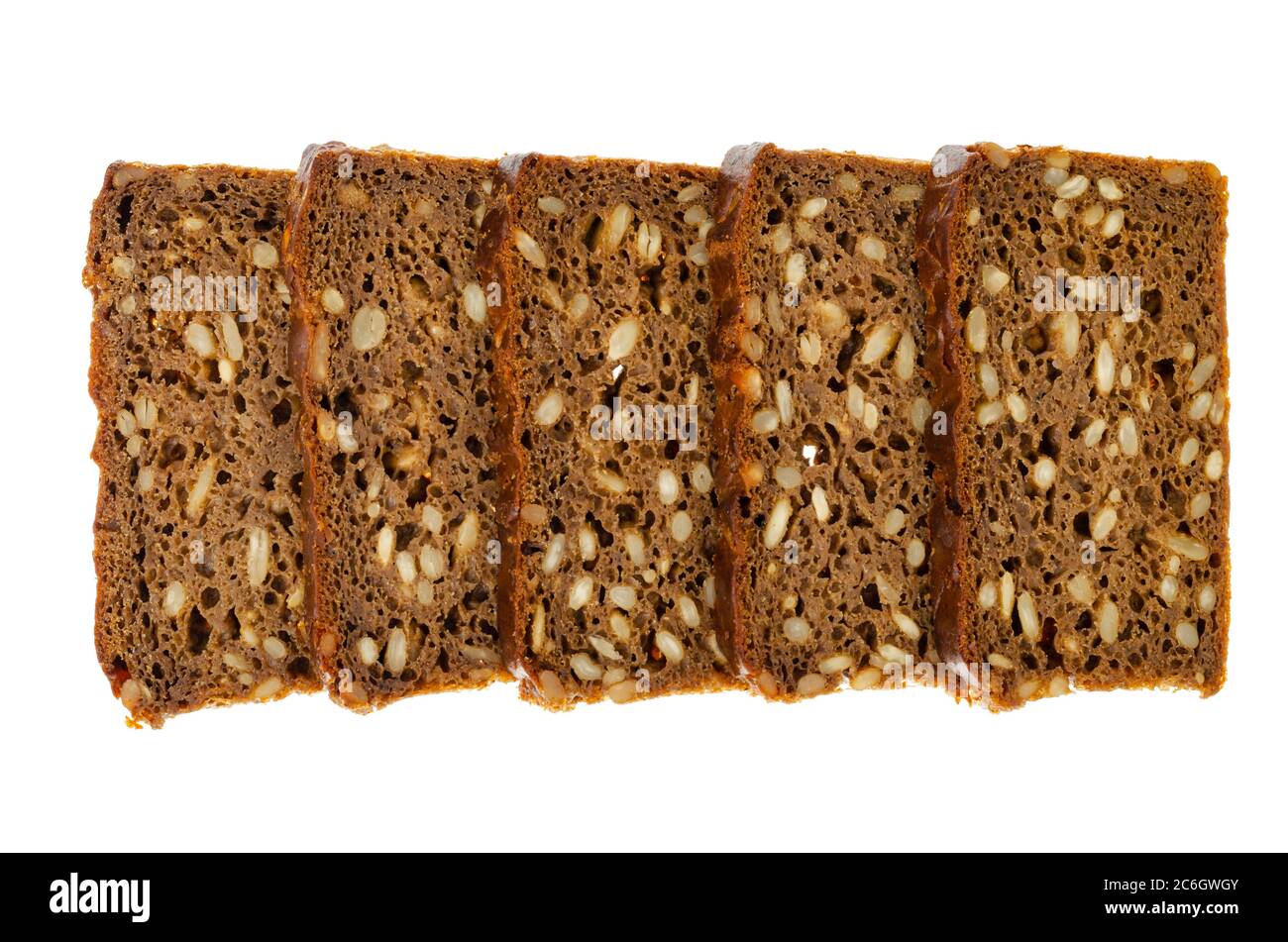 Slices of brown rye bread with sunflower seeds isolated on white background. Stock Photo