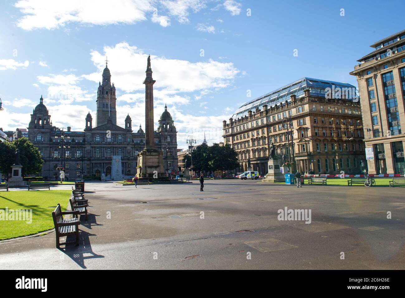 Glasgow, Scotland, UK. 10 July 2020. Pictured: George Square in Glasgow still shows signs of overnight showers, however the weather is to be bright sunshine on the day that Scotland makes all face coverings in shops mandatory.Glasgow, Scotland. Credit: Colin Fisher/Alamy Live News. Stock Photo