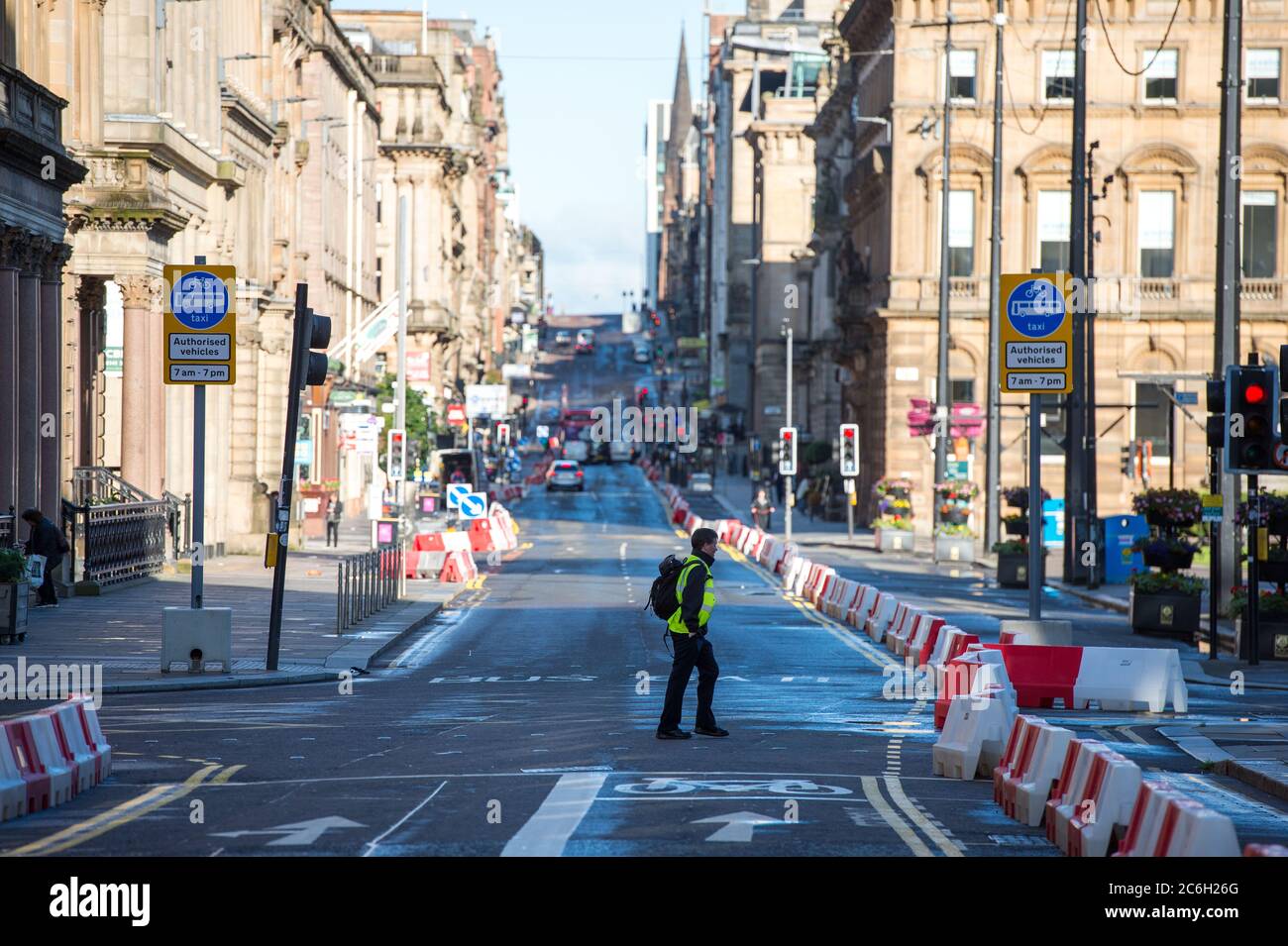 Glasgow, Scotland, UK. 10 July 2020. Pictured: George Square in Glasgow still shows signs of overnight showers, however the weather is to be bright sunshine on the day that Scotland makes all face coverings in shops mandatory.Glasgow, Scotland. Credit: Colin Fisher/Alamy Live News. Stock Photo