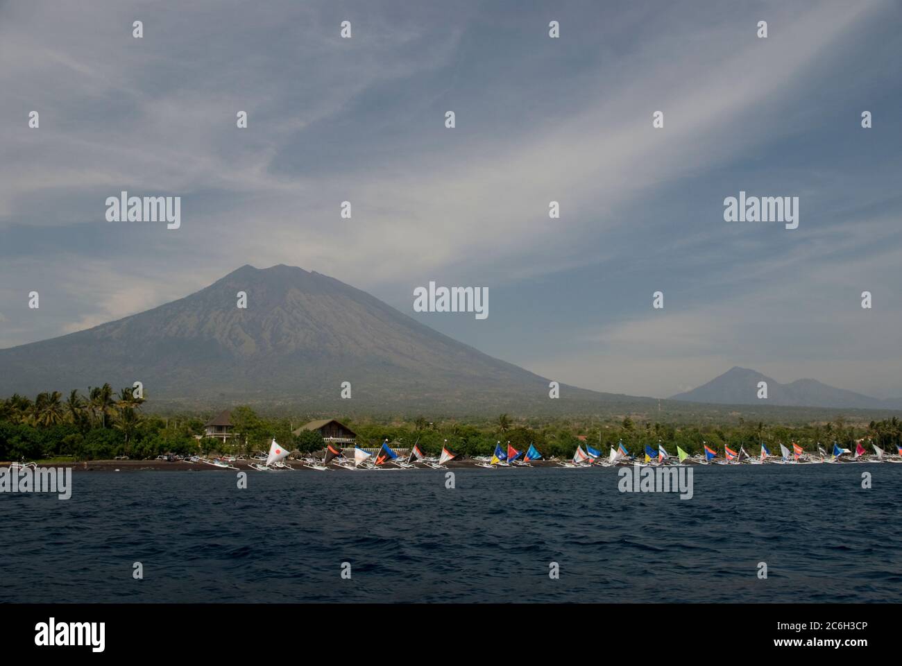Boats on beach with colourful sails with Mount Agung volcano in background, Tulamben, Bali, Indonesia Stock Photo