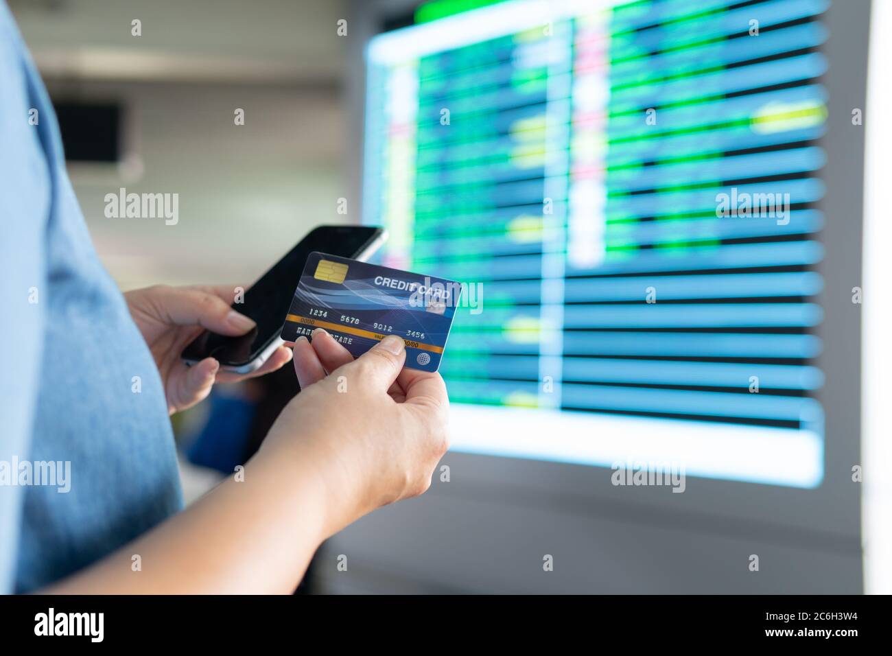 Business woman hand hold credit card to shopping internet online bill on computer, Debit saving purchase buy on table background. Shopaholic people re Stock Photo