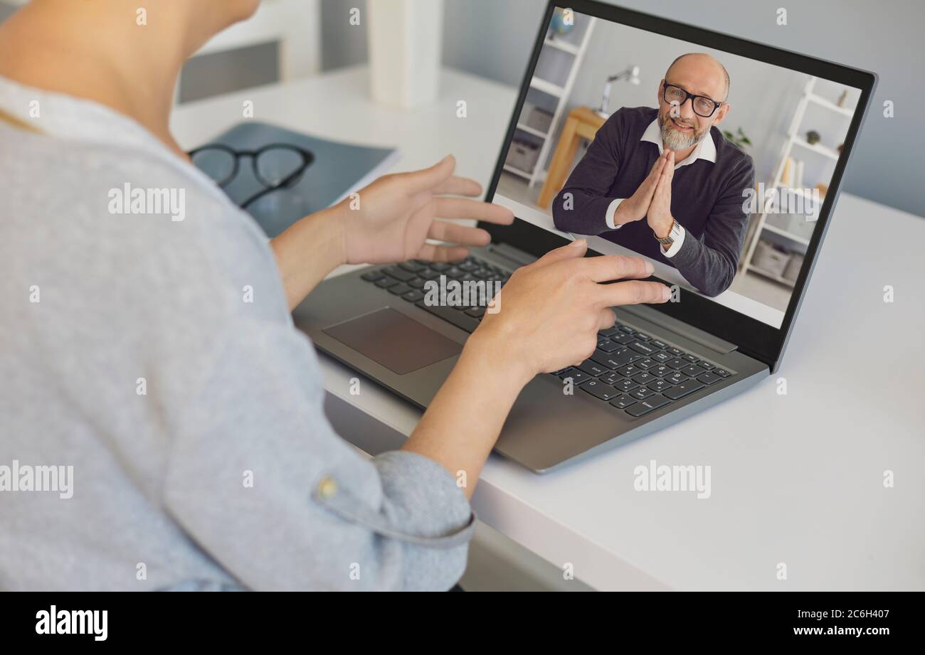 Senior man makes a video call chat using laptop technology webcam application at home. Stock Photo