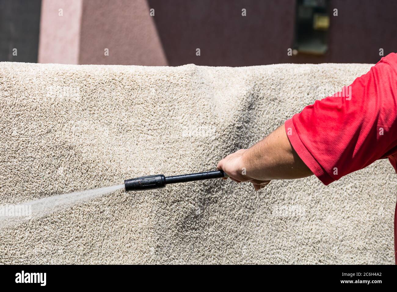 Close up of washing carpets with high pressure washer. Cleaning the