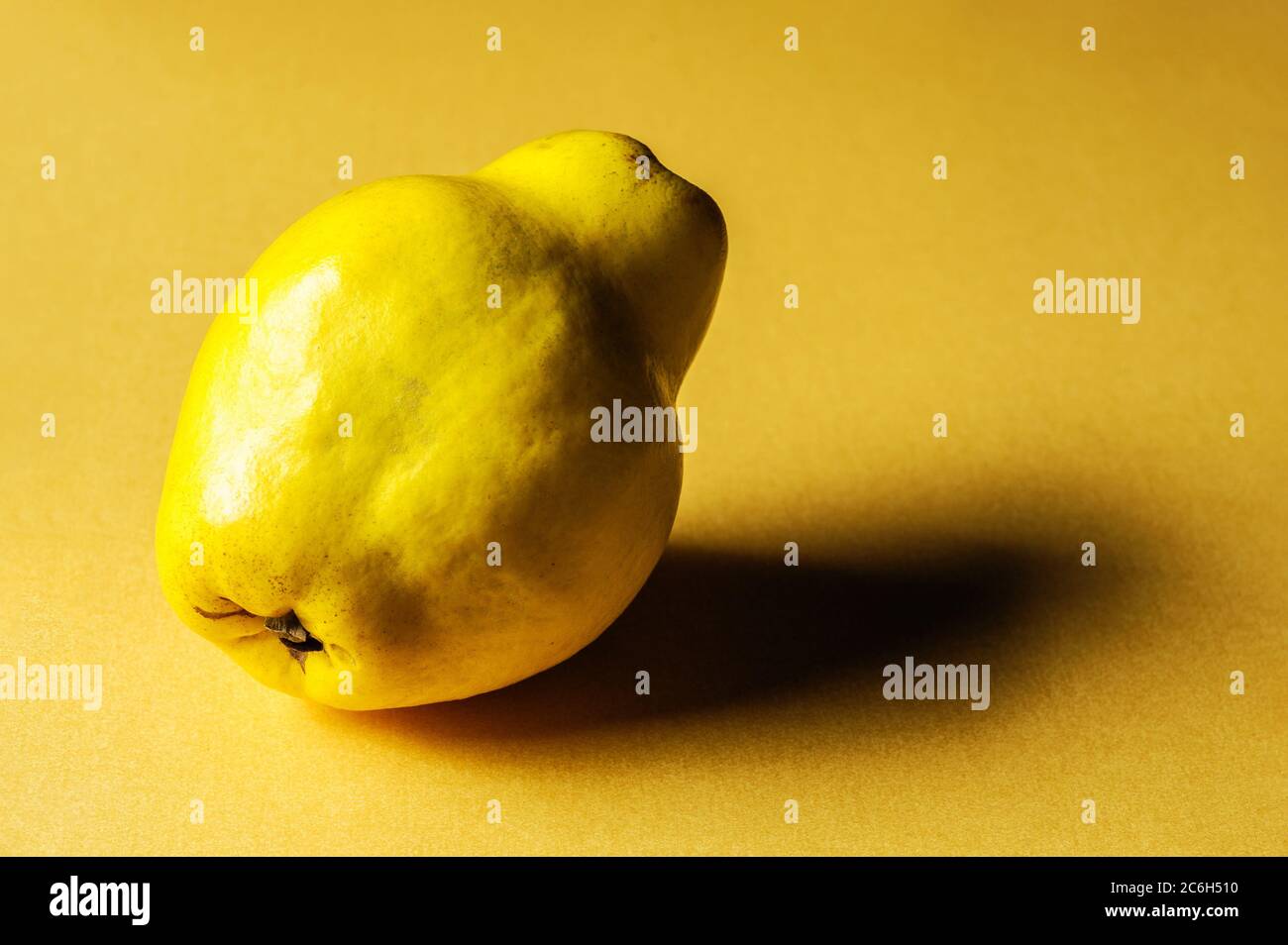 Quince On Yellow Background Stock Photo - Alamy