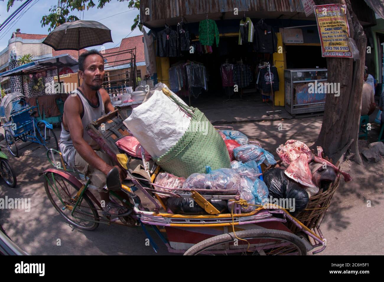 Man in cyclo transporting meat and cow's head on cyclo, Porong Sidoarjo, near Surabaya, East Java, Indonesia Stock Photo