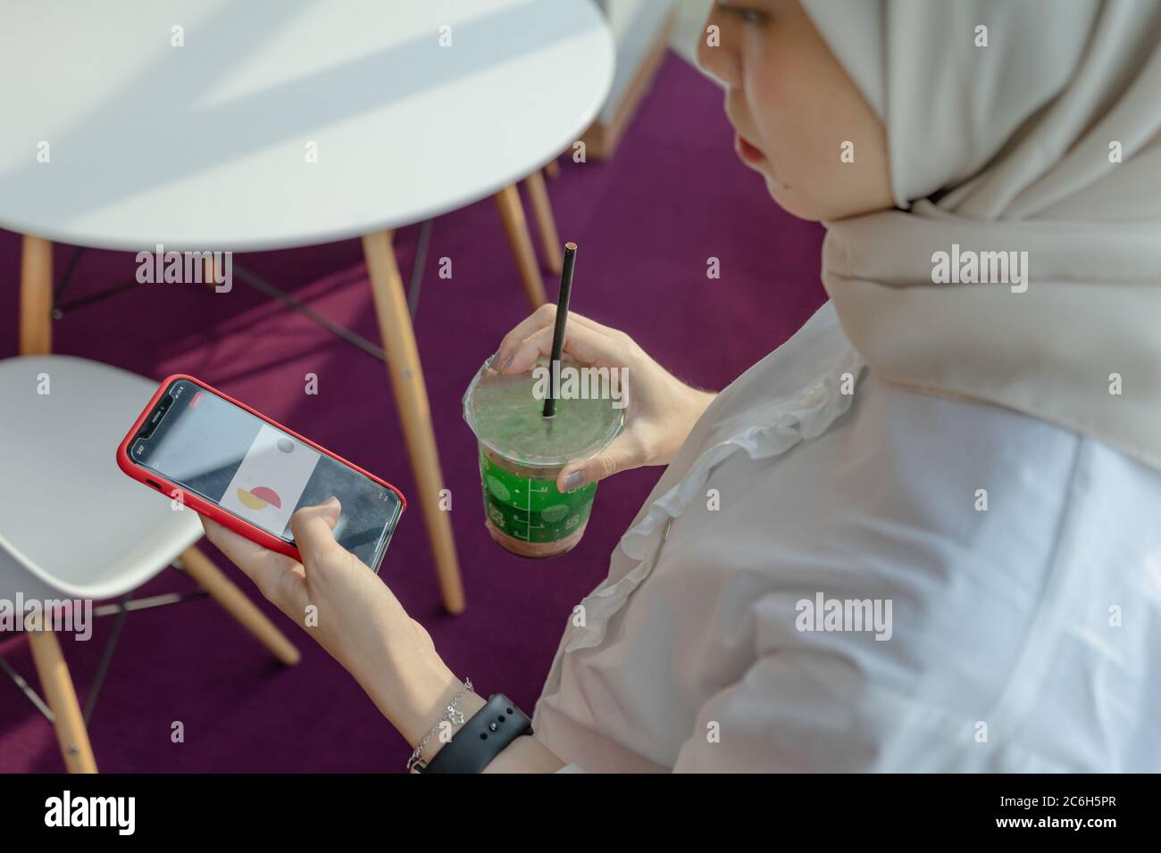 muslim women doing work with her gadget Stock Photo