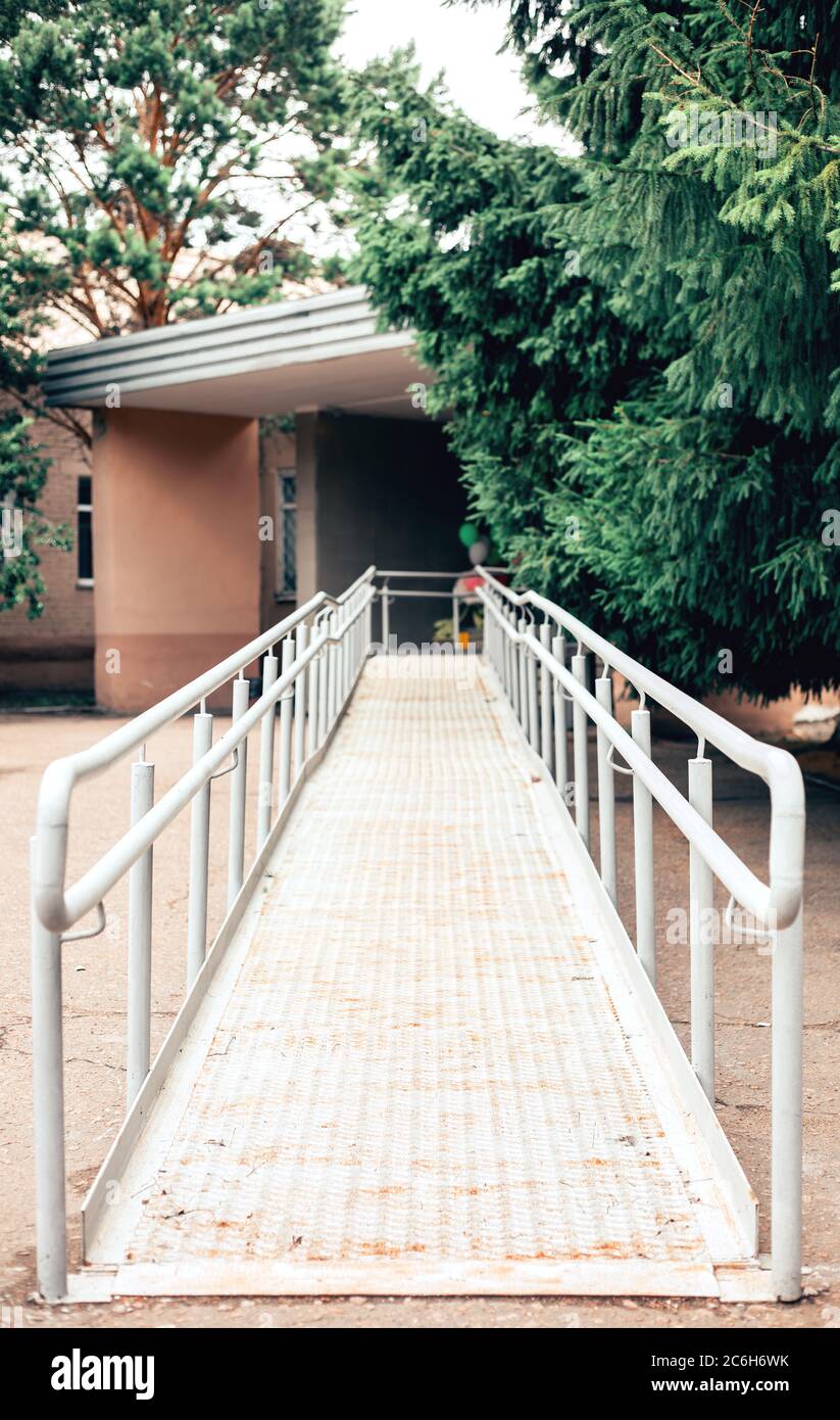 Metal ramp to support wheelchair users. Accessible environment for