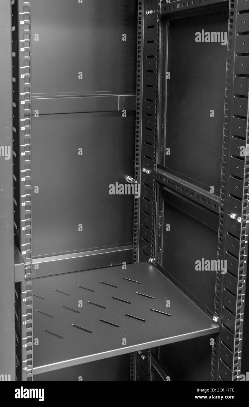Detailed image of a Computer and Network server cabinet showing the front meshed door open. Stock Photo
