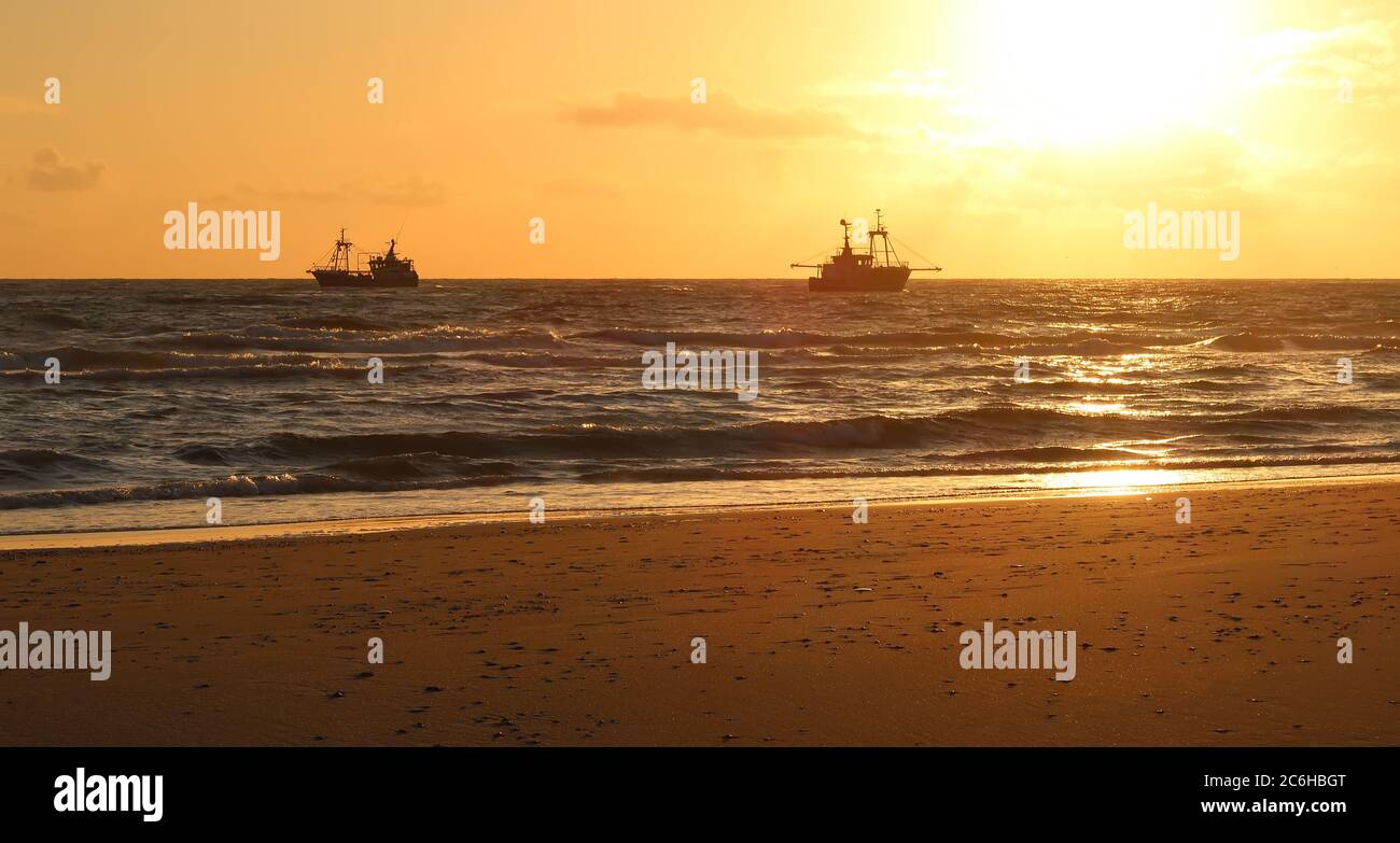 fishing boat in the sunset Stock Photo - Alamy