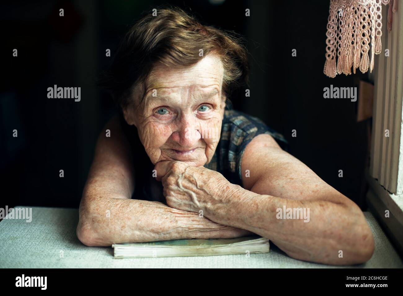 A very old woman, a portrait in her house. Stock Photo