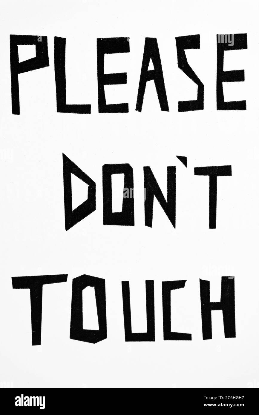 White wall with Please Don't Touch sign as written instruction Stock Photo