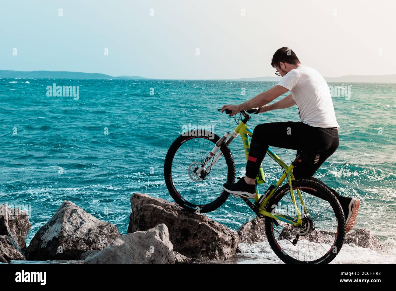 Man Standing Pose With Cycle High Resolution Stock Photography And Images Alamy https www alamy com splitcroatia may 2020 young man standing on the shore with a bicycle leaned on a beach rock waves hitting the shore on a windy day splashing him a image365492828 html