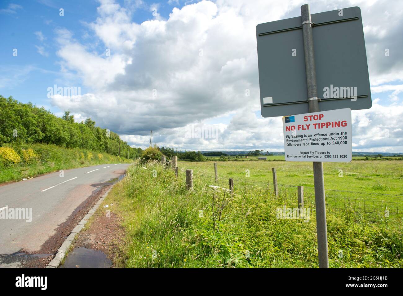 Larkhall, Scotland, UK. 10th July, 2020. Pictured: Illegally discarded rubbish on the side of a quiet road. Fly-tipping costs the UK's councils millions a year to properly dispose of. During the coronavirus (COVID19) lockdown, the council run waste disposal centres closed down leaving people to stock pile their rubbish which could not already be deposed of in the bin collections. Other people have resorted to dumping their rubbish in the country side. Credit: Colin Fisher/Alamy Live News Stock Photo