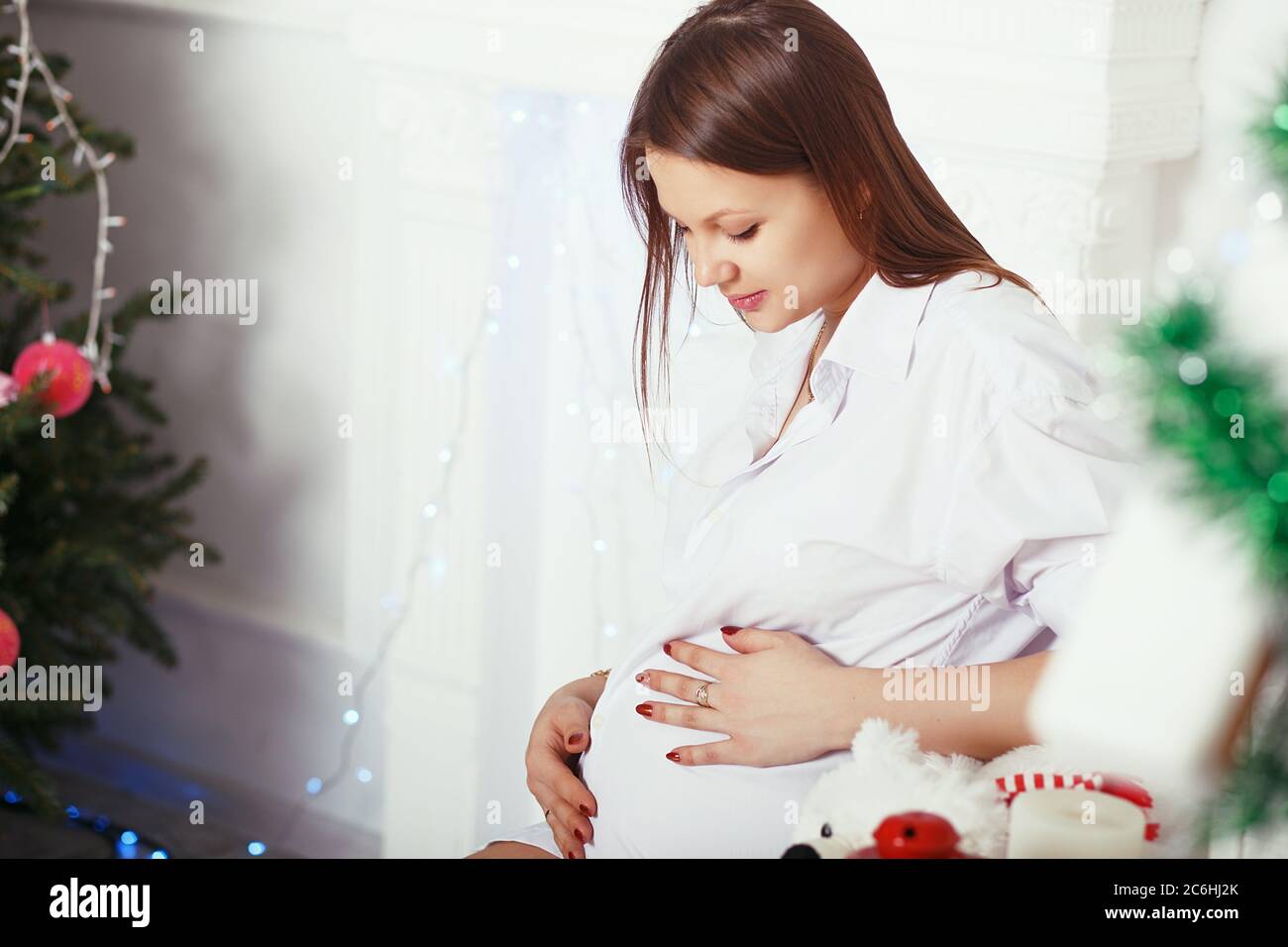 Happy Pregnant woman hugging her belly Stock Photo - Alamy