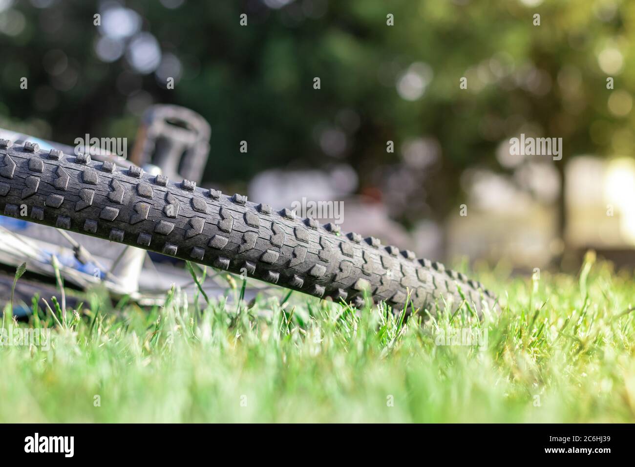 Closeup of a rubber bicycle wheel leaning on the ground, rubber cracked