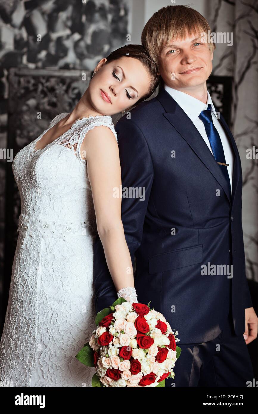Bride and groom in studio with vintage interior. Photo of happy newlyweds.  Beautiful fashion bridal couple Stock Photo - Alamy