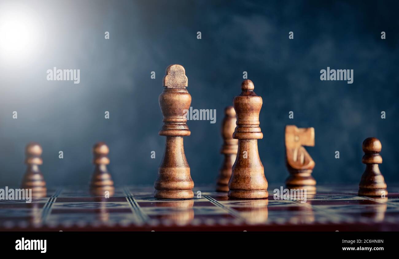 Powerful king and queen pieces on chess board battlefield Stock Photo