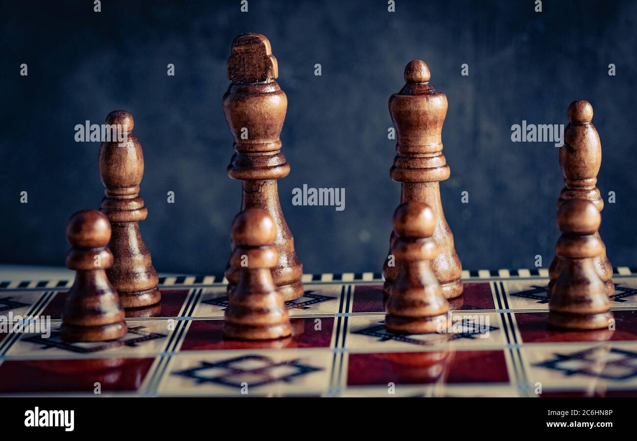 Classic wooden chess figures with reflection on board in front Stock Photo