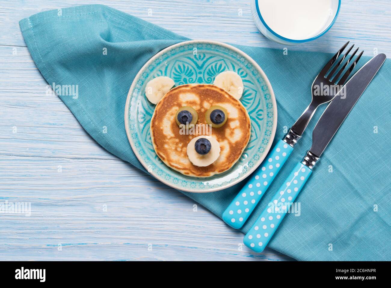 Funny pancake in a shape of teddy bear, food for kids idea, top view Stock Photo