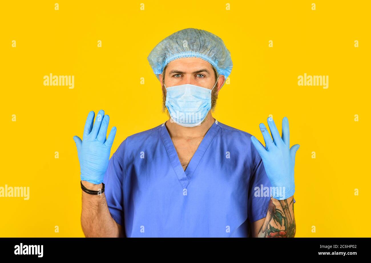 Man doctor uniform yellow background. Type of virus. Coronavirus concept. Expect virus to mutate. Human to human transmission. New viruses detected all the time. Beginning of virus outbreak. Stock Photo