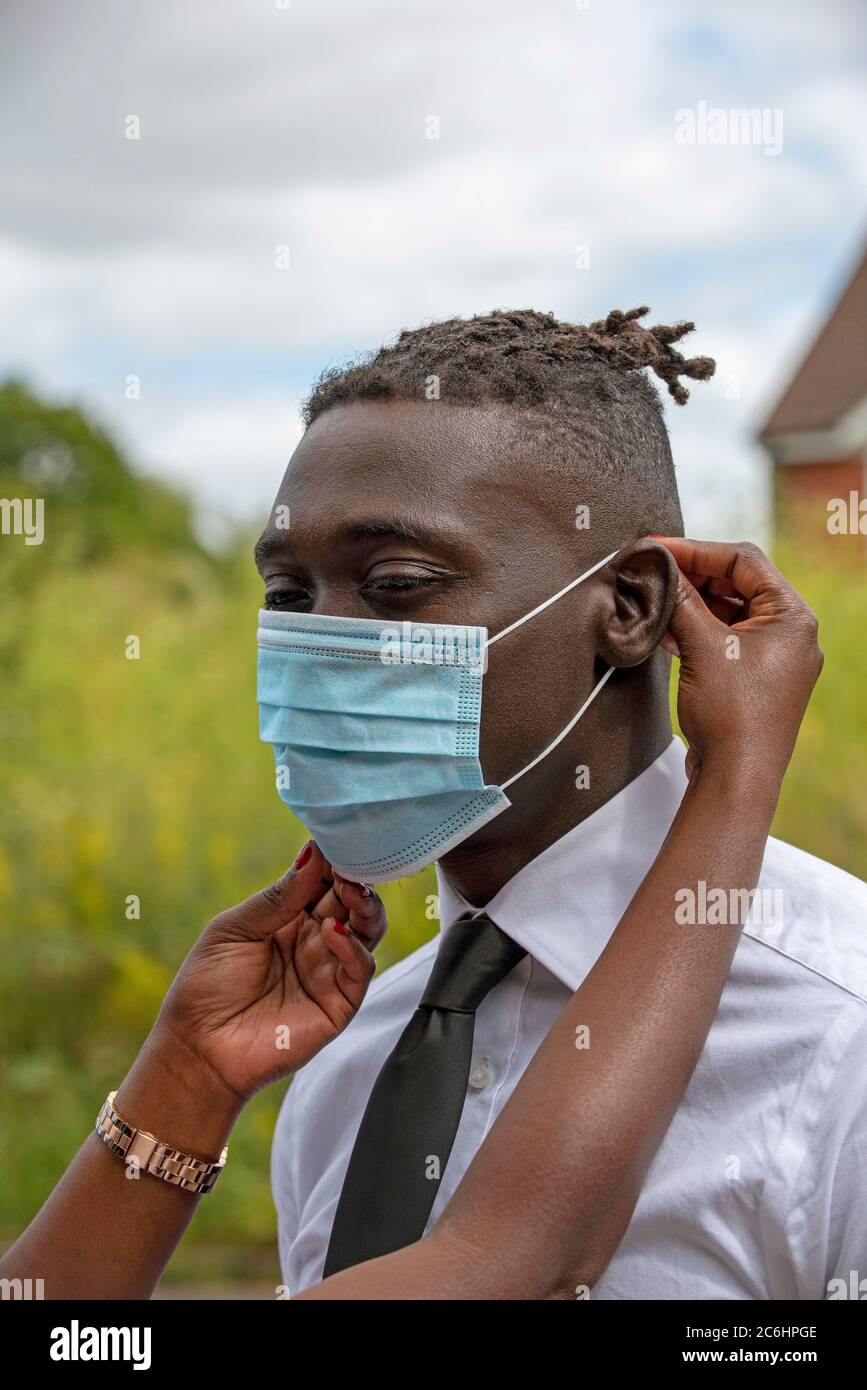Black Woman Putting On Facemask High Resolution Stock Photography and ...