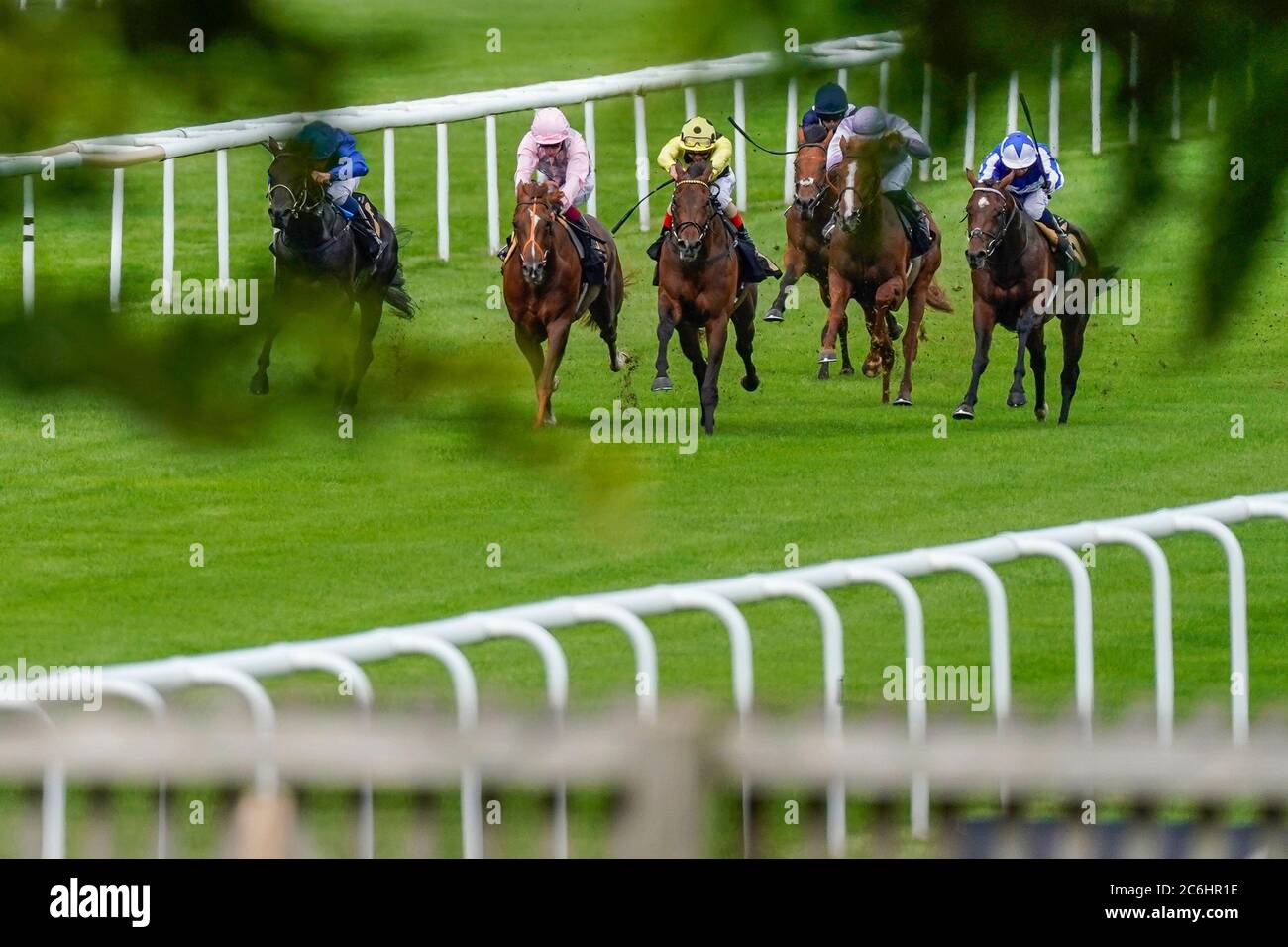 Andrea Atzeni riding Wise Glory (yellow) win The Cash Out At bet365 Handicap during day two of The Moet and Chandon July Festival at Newmarket Racecourse. Stock Photo