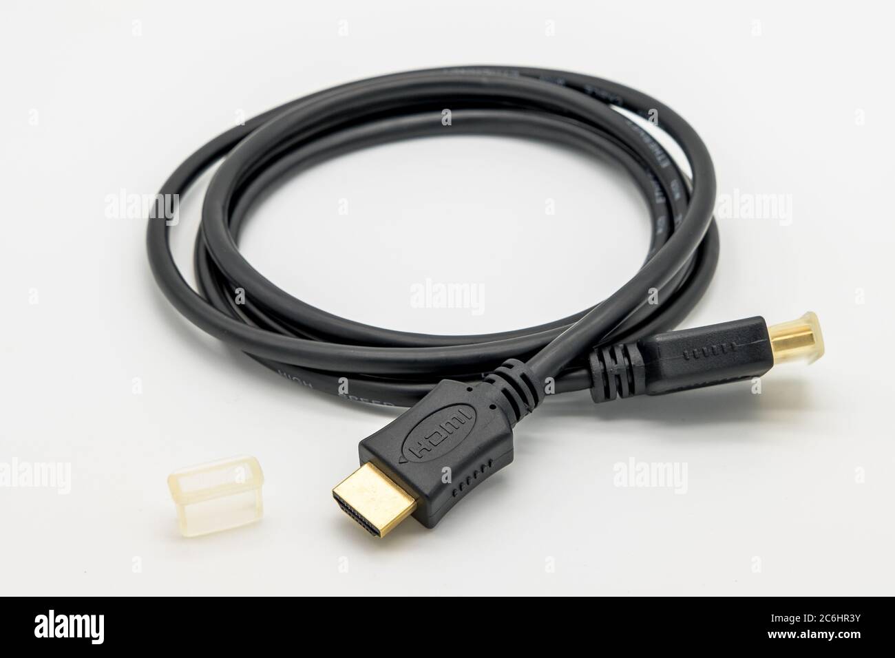 Detailed image of a high-performance HDMI computer and TV connection cable.  The gold plated HDMI connectors are visible as are the dust caps Stock  Photo - Alamy