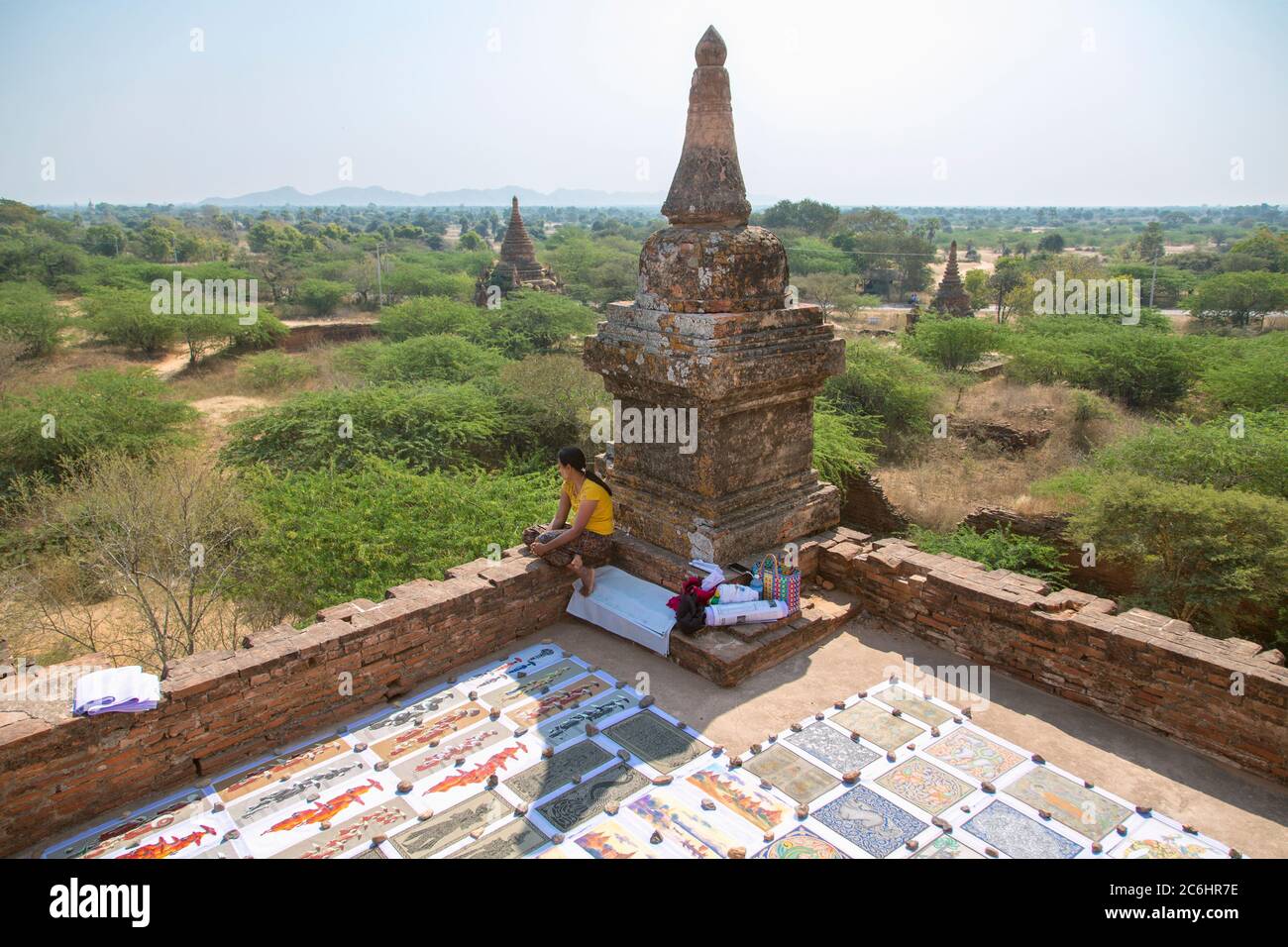 A young woman selling souvenir paintings at a temple in Old Bagan, Myanmar Stock Photo