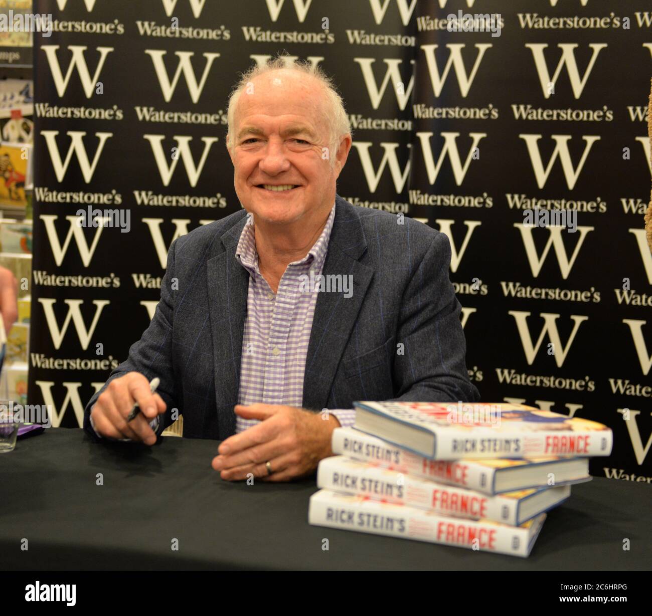 Rick Stein, British chef, restaurateur and presenter signs copies of Rick Stein's Secret France, a collection of 120 new recipes for real and simple F Stock Photo