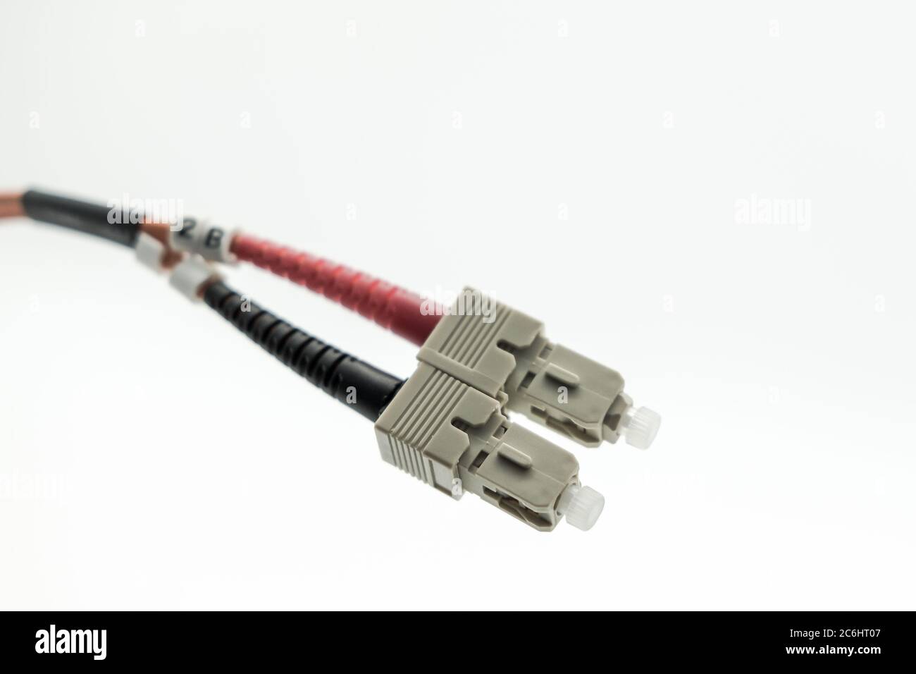 Macro image of super-fast Internet fibre optic patch leads used for high-speed, optical networking connections. Shown as a duplex pair of connectors. Stock Photo
