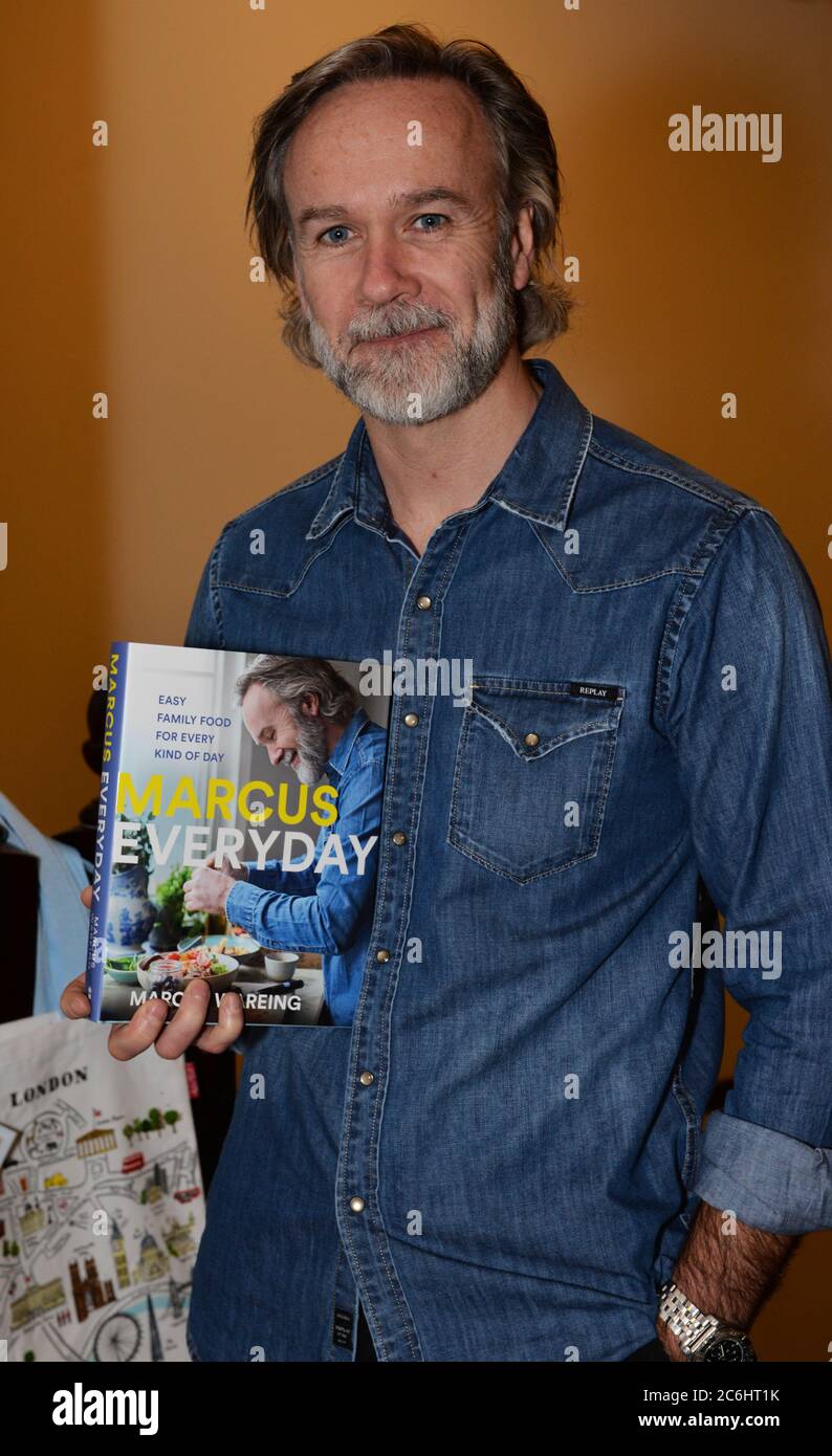 Marcus Wareing, Michelin-starred chef signs copies of his new recipe book, Marcus Everyday, featuring easy meals for every day of the week. Waterstone Stock Photo