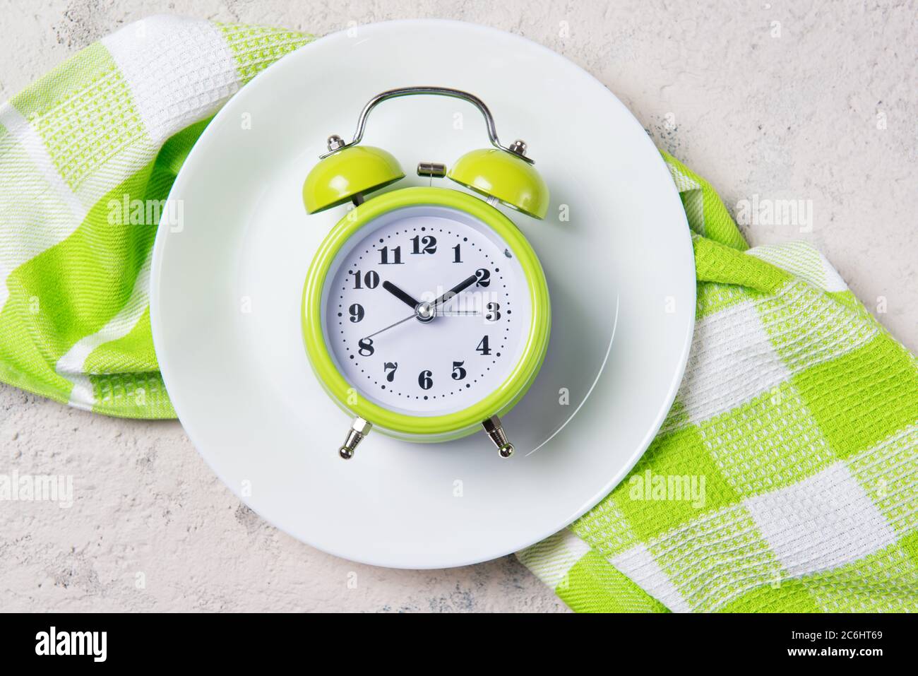 Alarm clock with bells on the plate, lunch time concept, top view with copy space Stock Photo