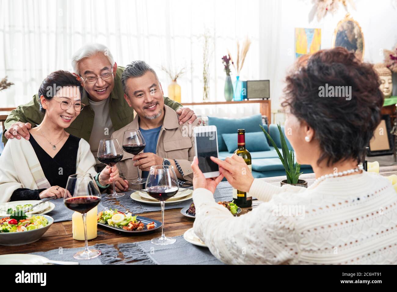 Happy dinner in old people use their phones to take pictures Stock Photo