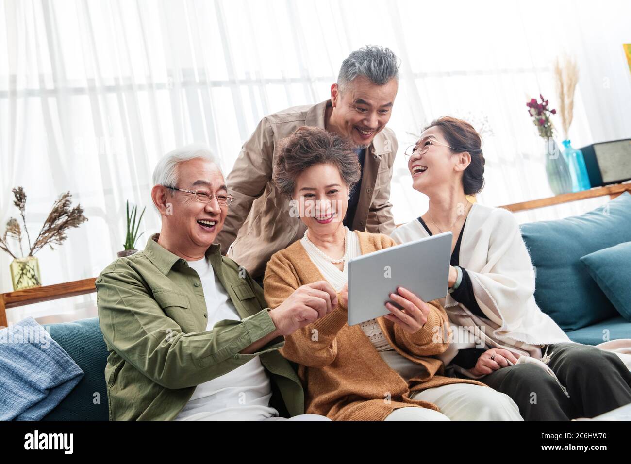 Happy middle-aged couples watch tablets Stock Photo