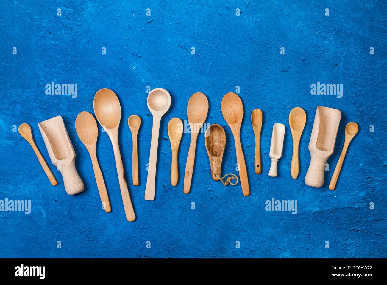 Wooden spoons on a textured classic blue background Stock Photo