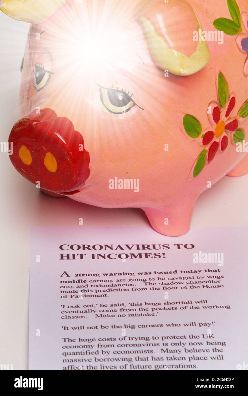 Financial concept image. Cost of  Covid 19 to economy and savings. light star.    Sad piggy bank empty purse.  Imaginary article about costs of Corona Stock Photo