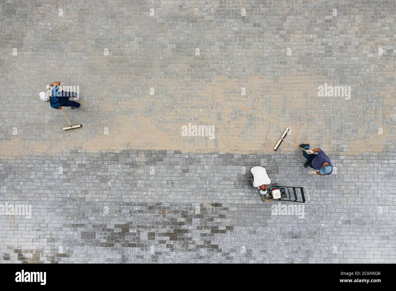 workers lay paving slabs top view Stock Photo