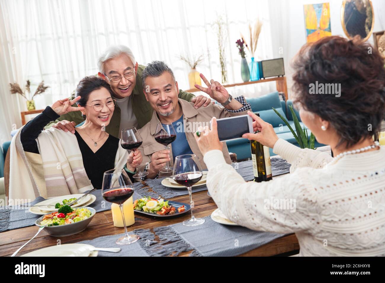 Dinner in old people use mobile phones Stock Photo - Alamy