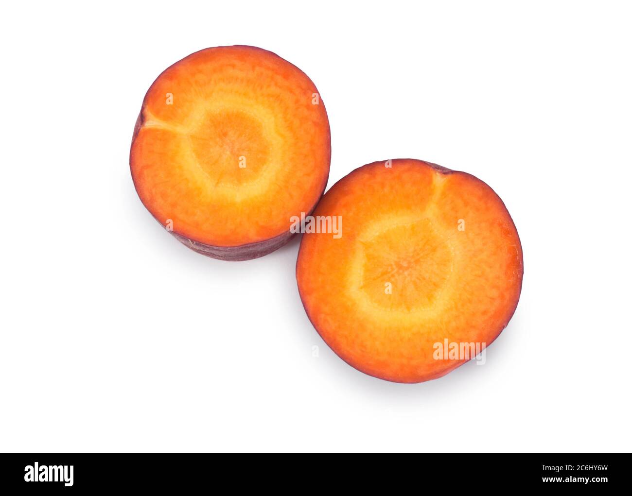 Studio shot of purple carrot cut against a white background - John Gollop Stock Photo