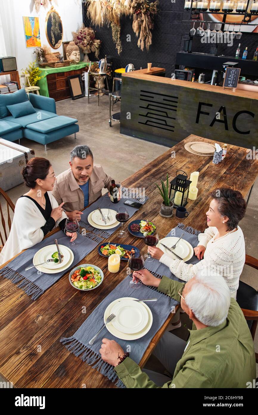 Old friends together for dinner in a restaurant Stock Photo