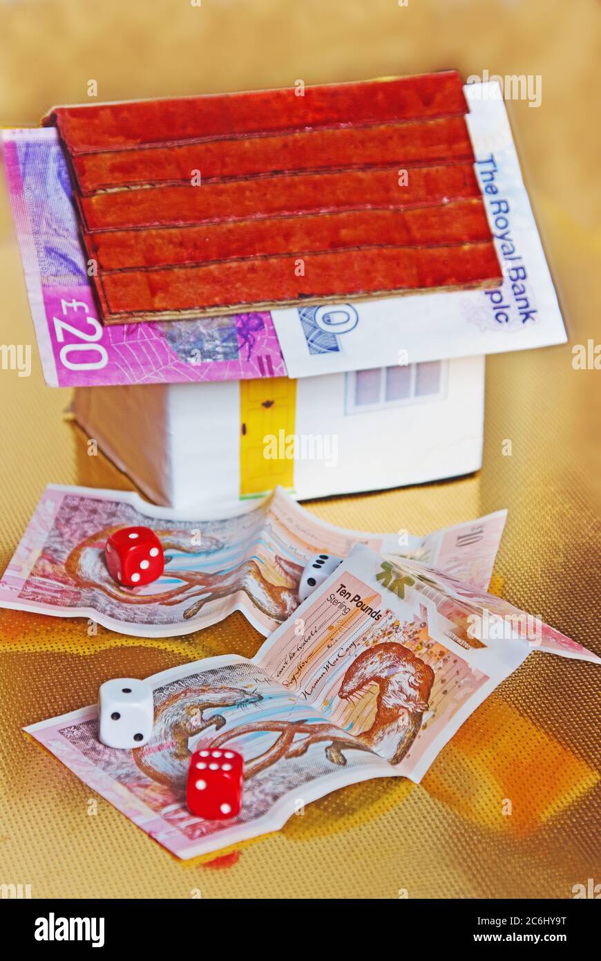Financial concept image. money surrounding  Toy, House,   Idea cost of house, bought, savings discipline needed, target, costs of home ownership, affo Stock Photo