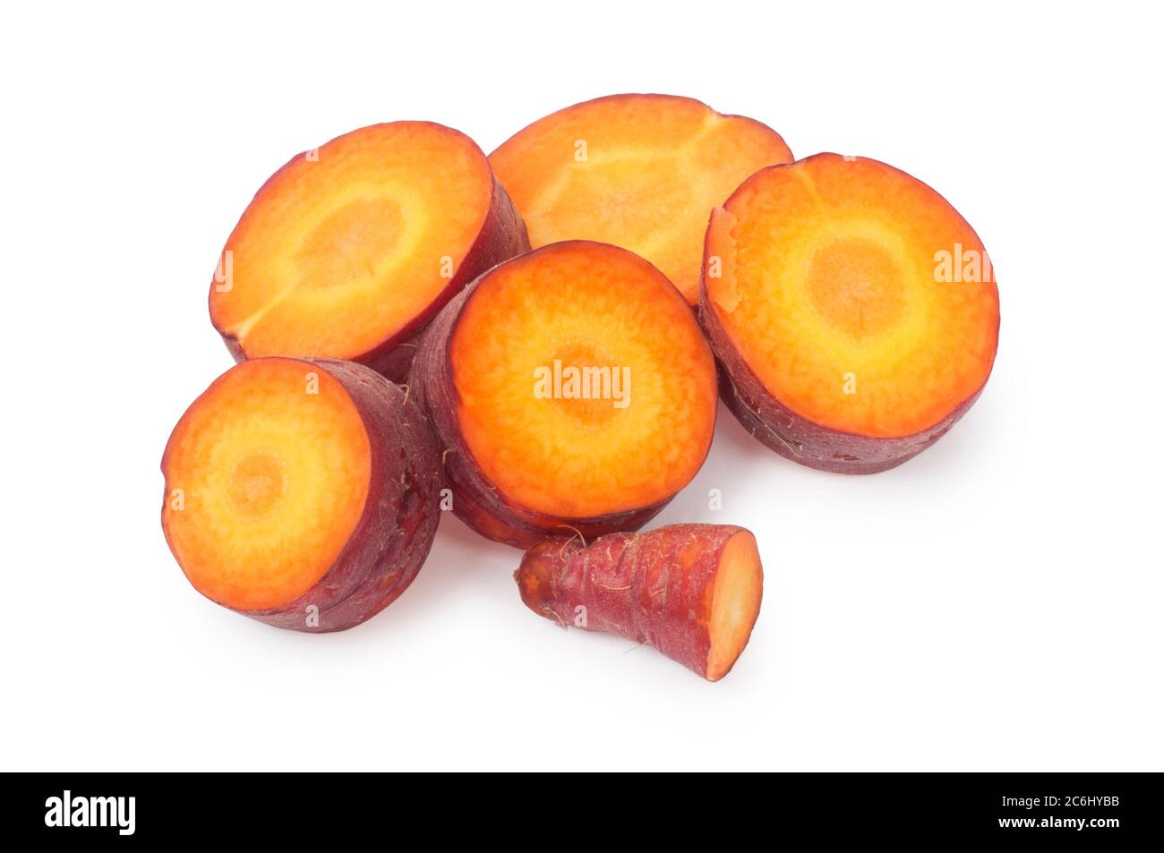 Studio shot of purple carrot cut against a white background - John Gollop Stock Photo