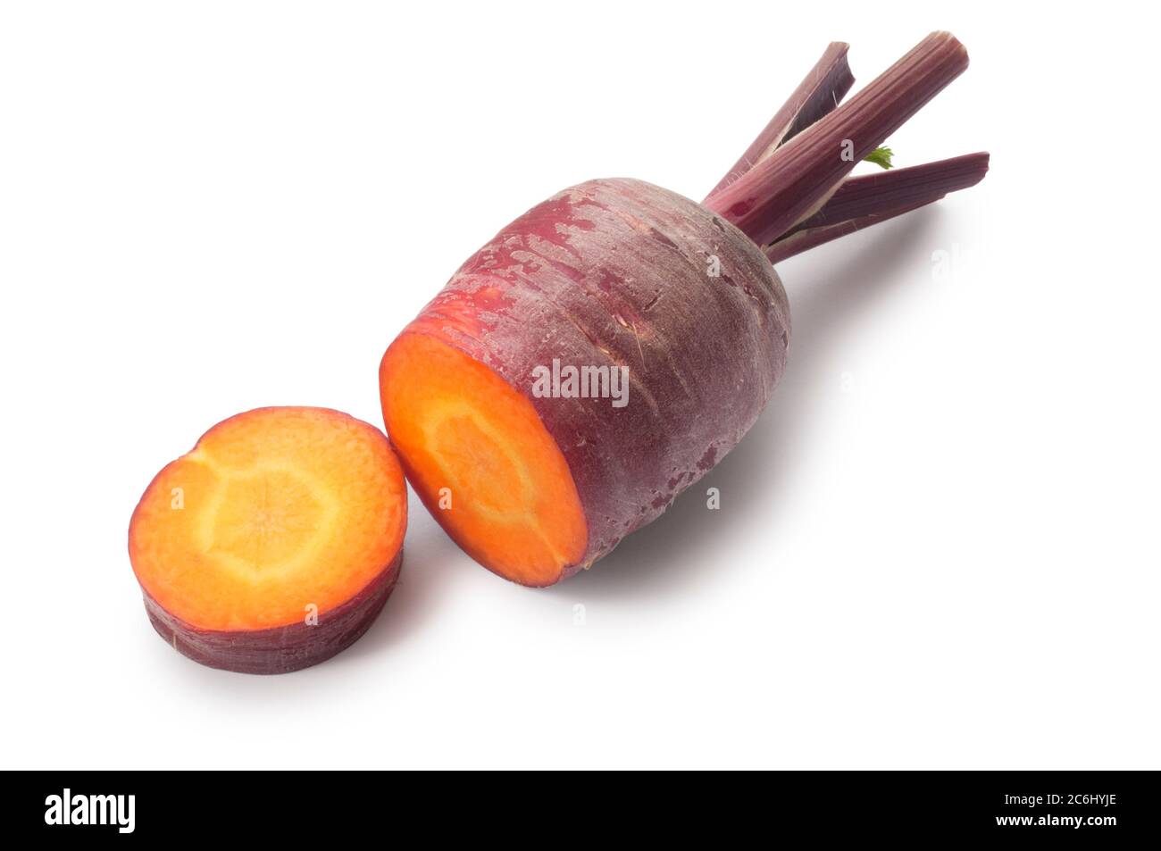 Studio shot of purple carrot cut against a white background - John Gollop Stock Photo