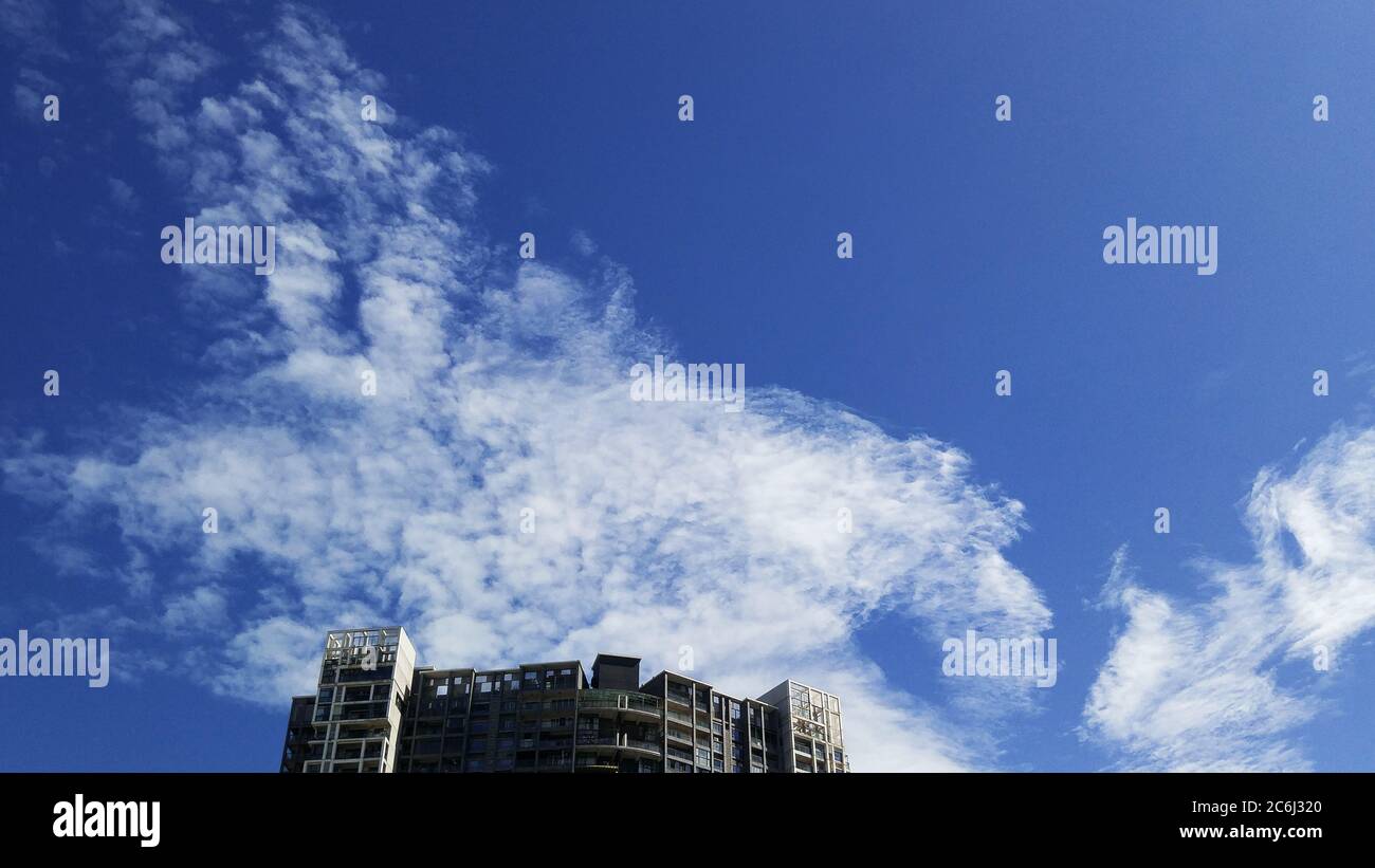 Shenzhen, China: residential buildings under blue sky and white clouds ...